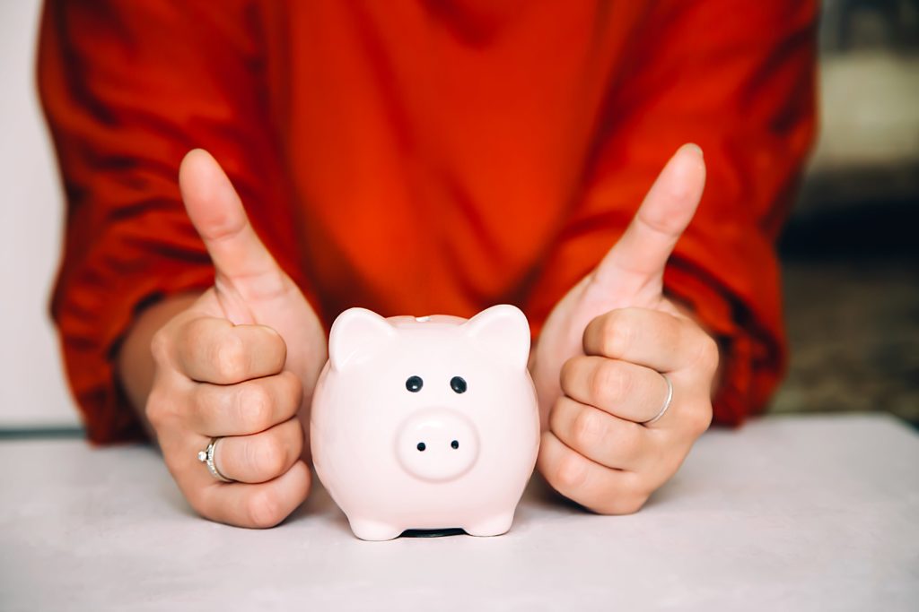 thumbs up next to the piggy bank 1119158 min